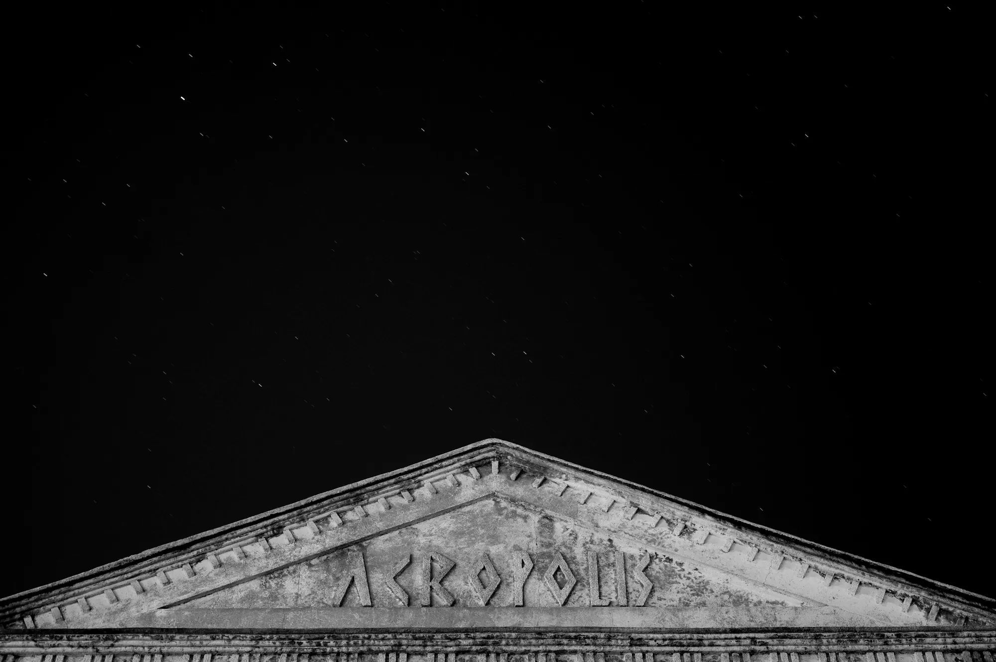 A carved stone pediment at night