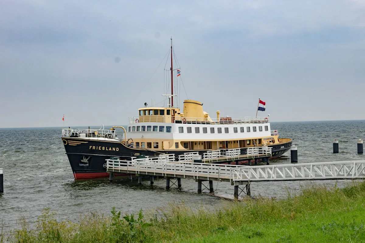 A black and white steamer tied up at a pier